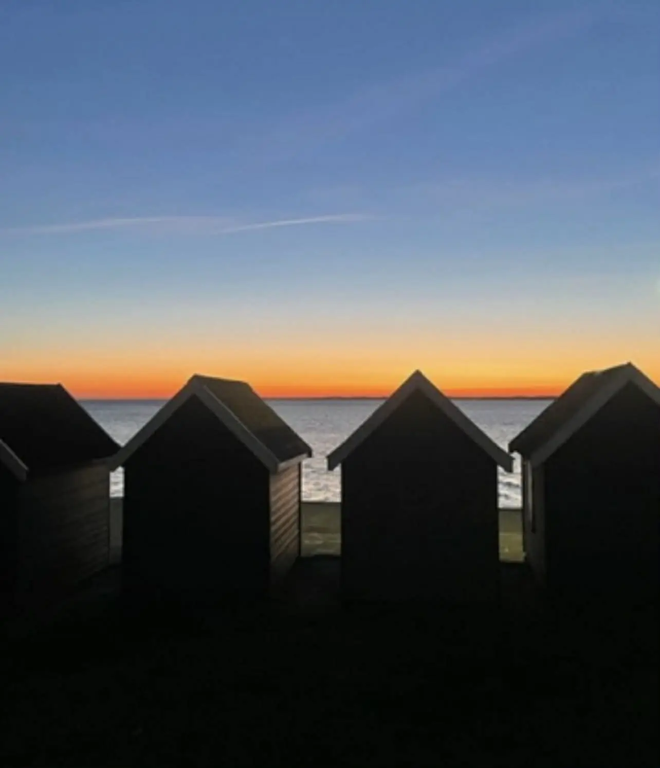 Dusk shot of huts by the beach